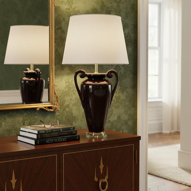 Bring dramatic elegance to your space with this vintage Hollywood Regency ceramic amphora‑urn table lamp, finished in a...