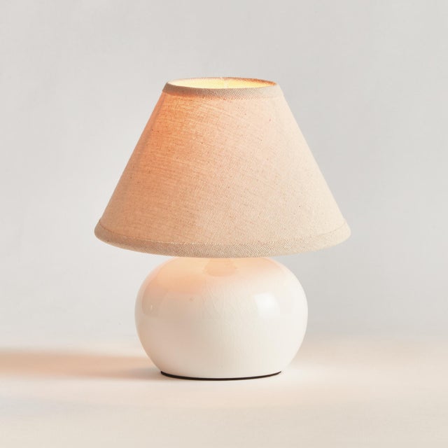 This sweet little offwhite ceramic lamp is at home in any coastal setting. The texturedCream shade and petite base make it...
