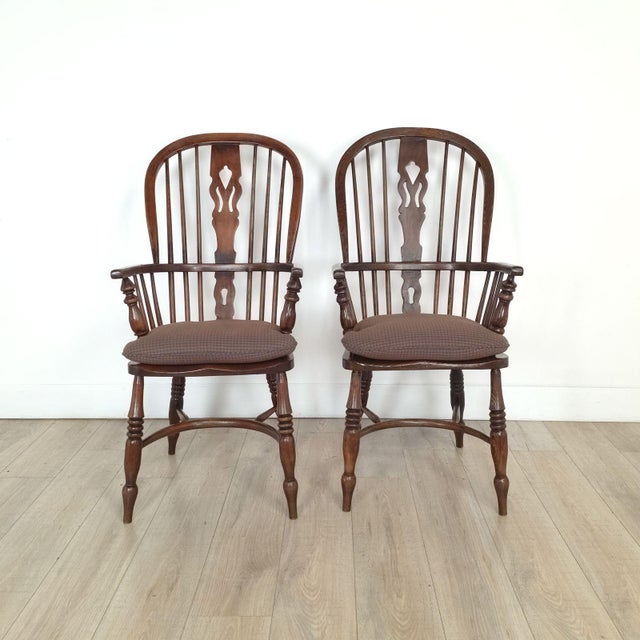 A pair of antique English oak Windsor chairs, 19th century. Seat height 18".