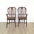 A pair of antique English oak Windsor chairs, 19th century. Seat height 18".