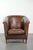 This sleekly designed sheepskin club armchair in elegant Art Deco style features a loose seat cushion and is stylishly...