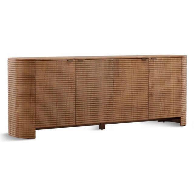 Crafted from mindi wood and veneer in a warm light brown finish, this sculptural sideboard brings organic sophistication...