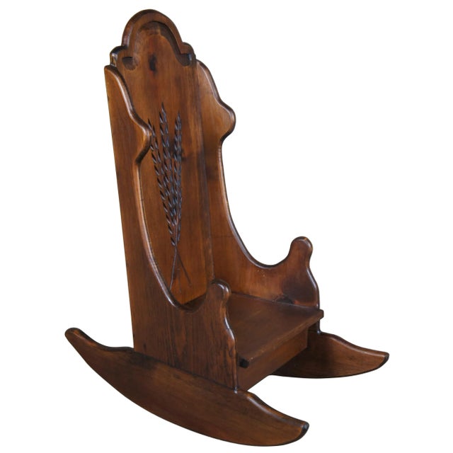 Circa 1970s childs or doll sized rocking chair. Made from pine with sheaf of wheat carved back.