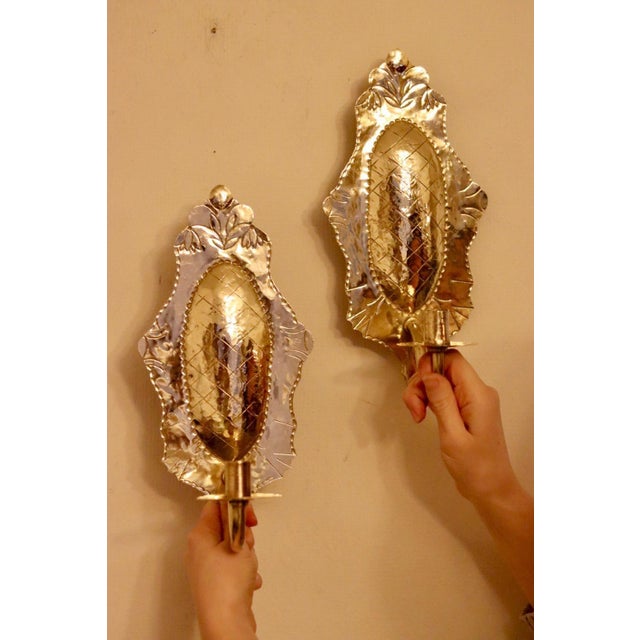 Made in Sweden A breath-taking mid-century duo of exquisite Swedish brass wall sconces, showcasing captivating hammered...