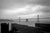 San Francisco, California, 1960s, black and white view of the Bay Bridge on a cloudy day. The photograph captures the...