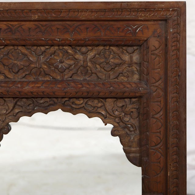The crisply carved arch and frame was originally a Rajasthani window and would have held small shutters inside. In a rich...