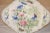 19th century shaped serving dish with multicolored transfer decoration depicting a garden with florals and butterflies in...