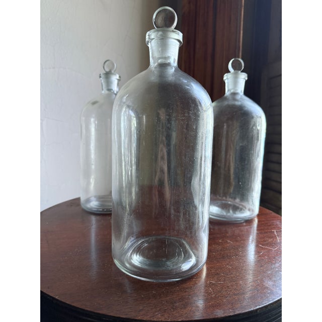 Mid-20th century clear glass reagent / apothecary bottle, originally used in laboratory, pharmaceutical, and chemical...