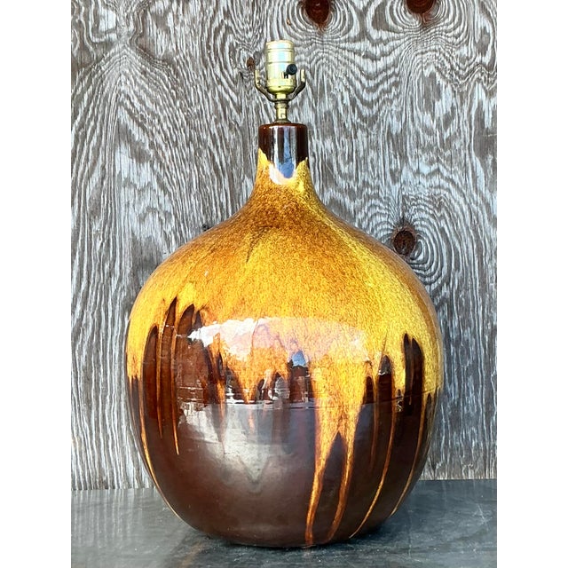 This stunning vintage Mid-Century Modern (MCM) drip glaze lamp is a true statement piece, featuring a beautifully rounded...