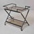 This two-tier bar trolley is constructed in black-lacquered metal cast to simulate bamboo segmentation throughout. The top...