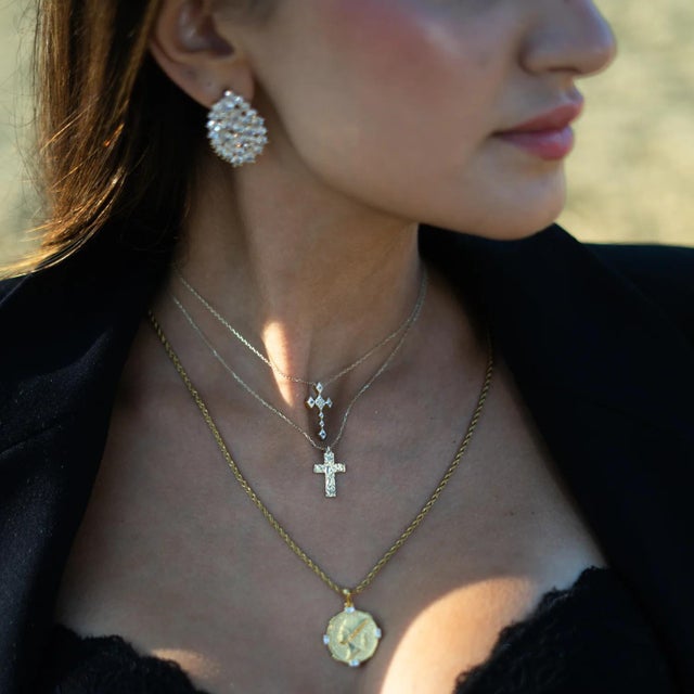 Illuminate your style with timeless elegance and spiritual meaning. The Eternal Grace Diamond Cross Gold Necklace is...
