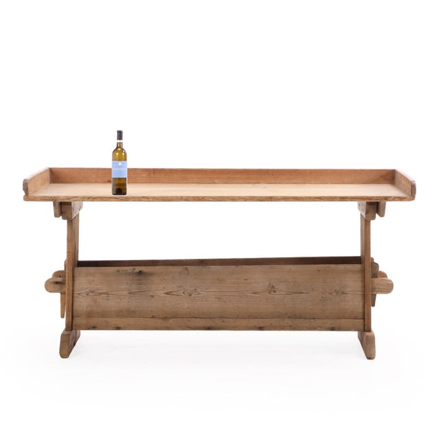 A charming and functional baker’s table in pine, featuring a three-sided galleried top typical of French work tables from...