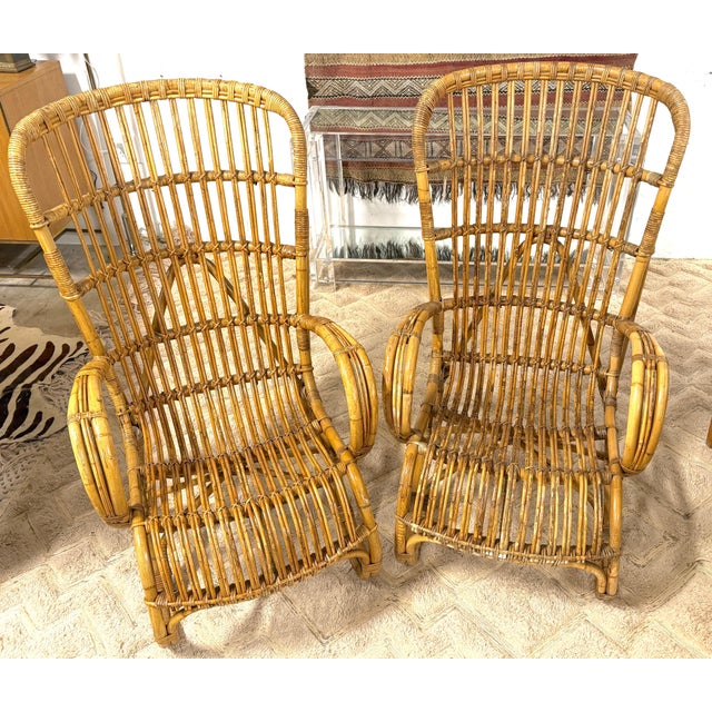 Pair of Italian Mid-Century Rattan High-Back Lounge Chairs in the Style of Franco Albini Italy, circa 1950s An elegant and...