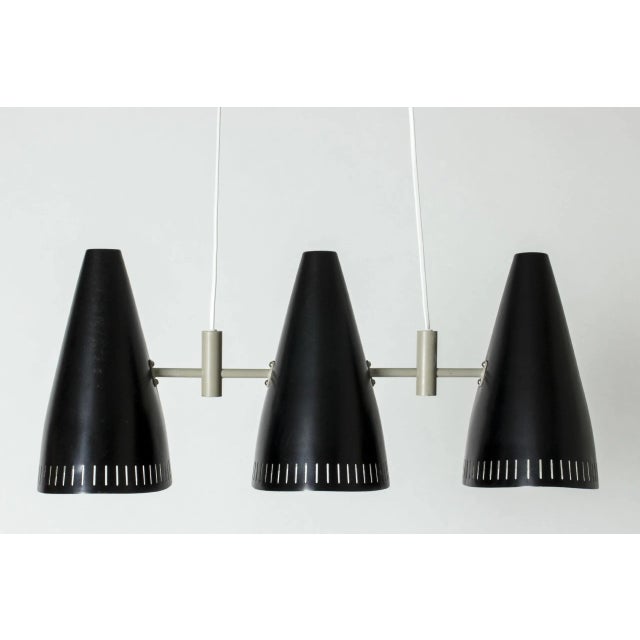 Very cool ceiling lamp by Eje Ahlgren, with three black lacquered shades. Sleek graphic look with light grey lacquered...