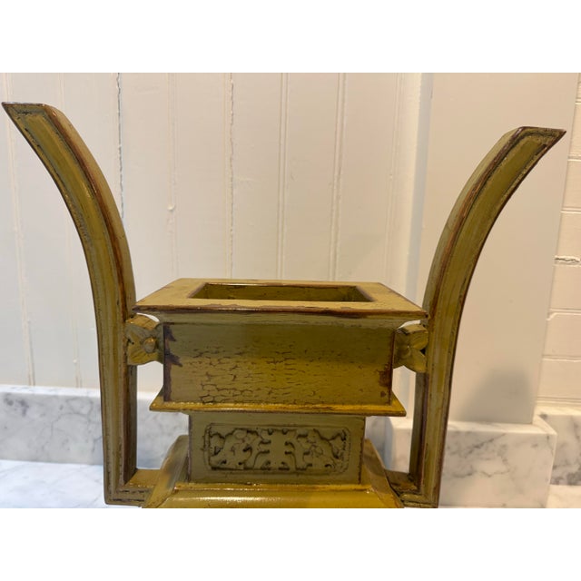 A unique vintage planter in an Asian design. Unusual shade of pea green.