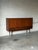 This impressive sideboard features smooth sliding doors, interior shelving, and a built-in dry bar area with a mirrored...
