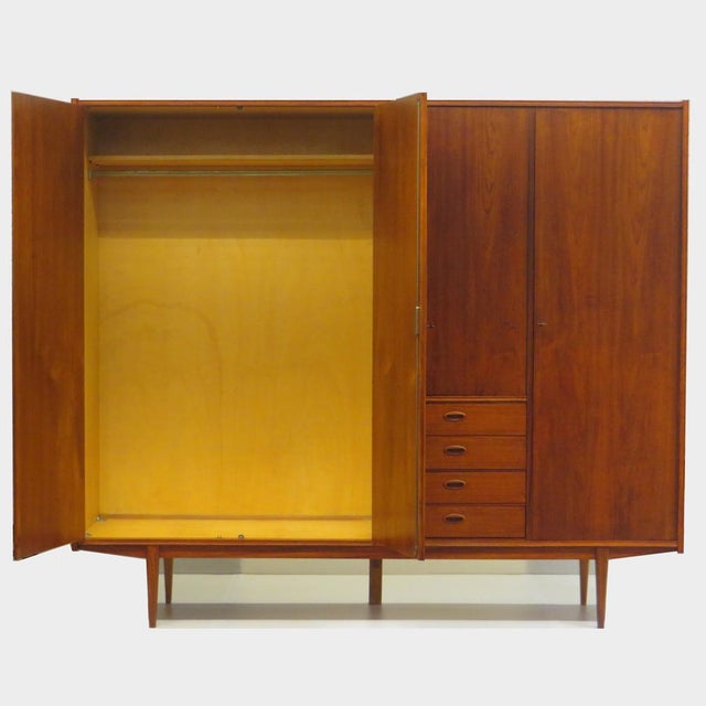Vintage mid century modern Scandinavian design wardrobe in teak from the 1960s. This Danish wardrobe features four doors...