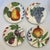 Set of 4 heavy ceramic fruit, salad or desert plates. Each plate has a different painted fruit on it and together the set...
