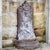 Wall fountain made of patinated metal with a detailed relief back panel. The figurative depiction and finely crafted...
