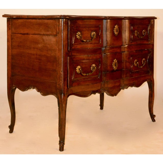 18th century French Louise XV walnut serpentine front commode. This commode has heavy cast brass bail pulls and key...