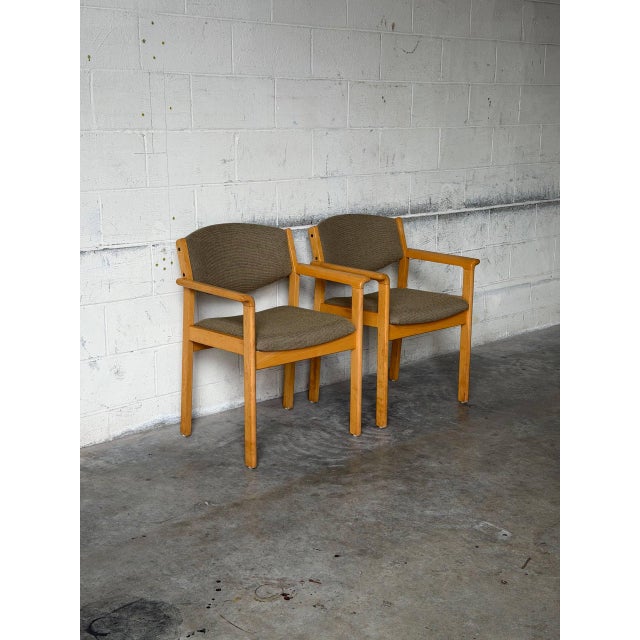 This pair of dining armchairs features a padded backrest and streamlined frame. Their clean profile beautifully reflects...
