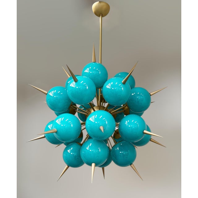 Italian sputnik chandelier with 24 Tiffany blue Murano glass globes and solid brass spikes mounted on brass frame in satin...