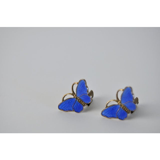 An exquisite pair of silver and enamel butterfly earrings. The ear clips are beautifully crafted in a warm silver with...