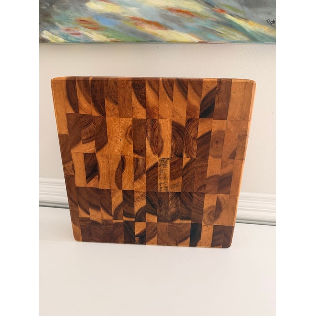 Substantial Mountain Woods end-grain acacia butcher block cutting board featuring a richly varied mosaic of natural wood...
