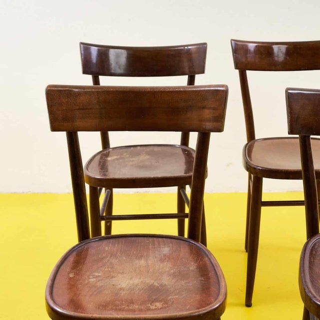 This charming set of wooden chairs is a perfect combination of functionality and retro style. With their sturdy...