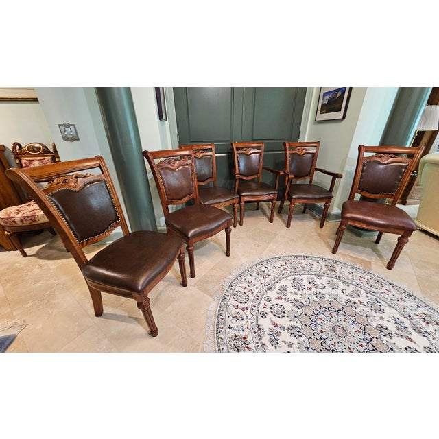 4 side chairs and 2 arm chairs in hardwood solids with cherry veneers. Carved details and hand-applied glaze finish in...