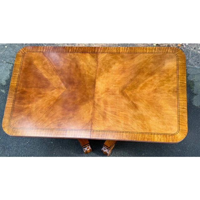 Gorgeous 18th century inspired dining table by Henredon. Features a banded mahogany top with striking grain, double...