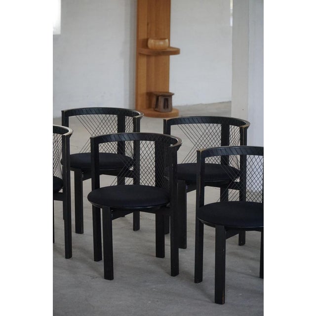 A beautiful set of eight “string” dining chairs designed by niels jørgen haugesen for tranekær furniture, denmark, in the...