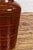 An artisan brown glaze vase with black concentric motifs and tapering lines. This contemporary artisan vase captivates...