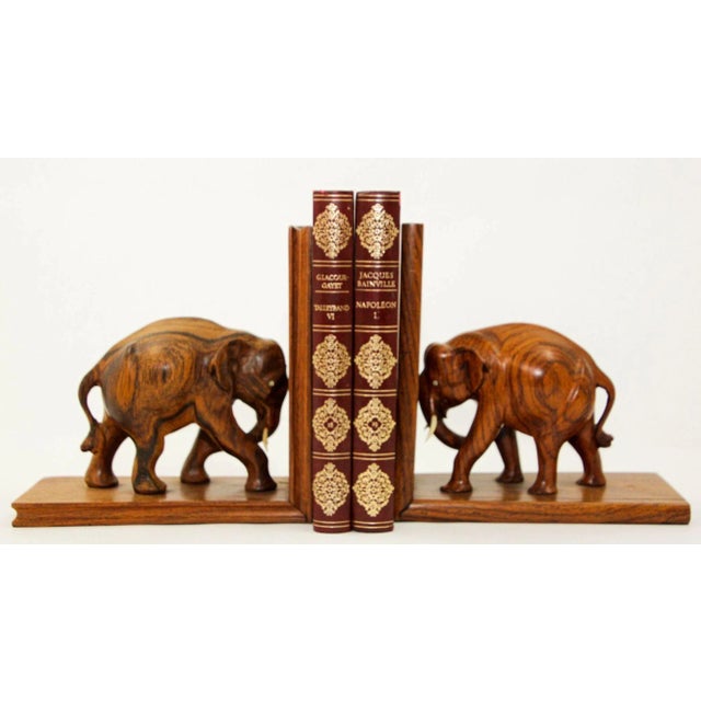 Large vintage Asian hand-carved wood elephant bookends. Vintage 1940s wooden bookends with carved elephant sculptures...
