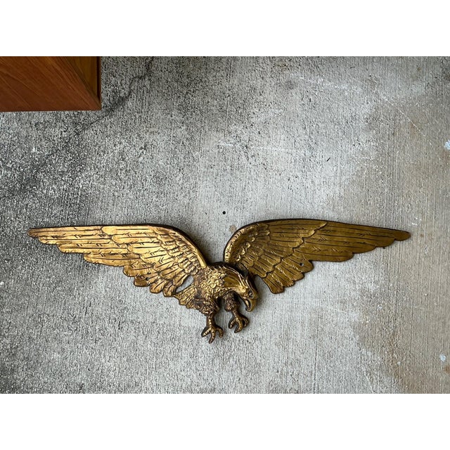 Make a bold decorative statement with this vintage gold-painted metal eagle wall sculpture, a commanding piece that...