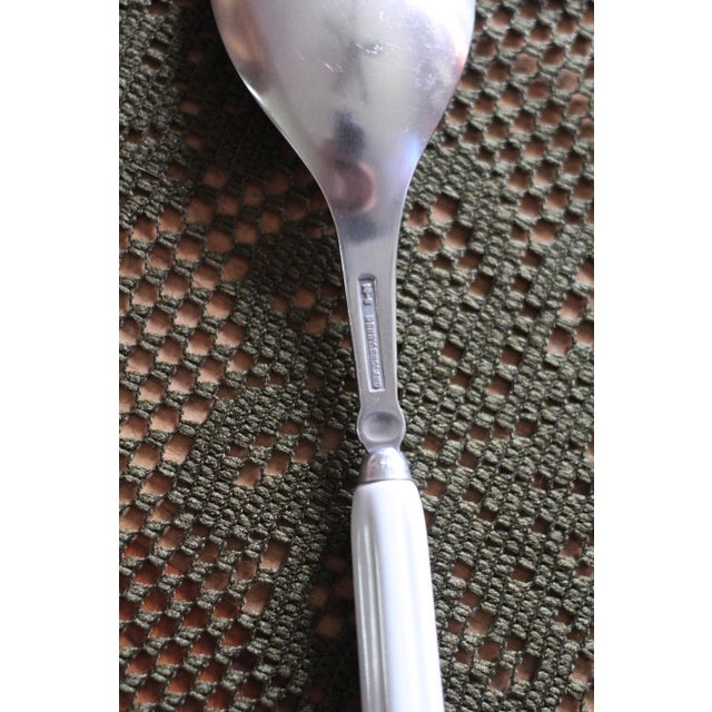 Wonderful design of flatware with a ceramic handle in white, orange red, and brown. Mushroomed at the bottom with...