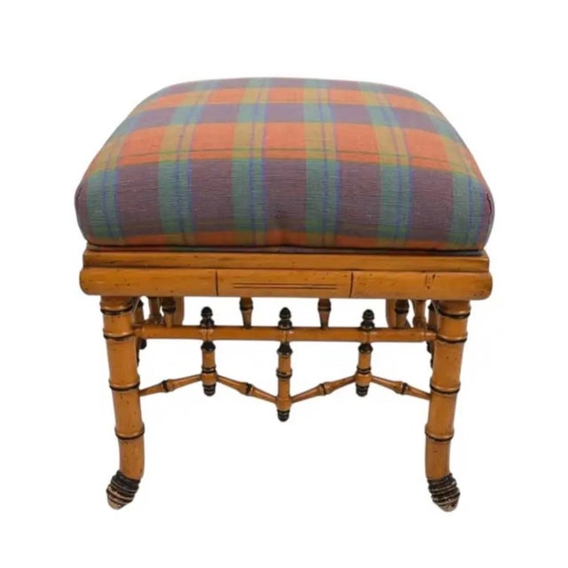 William Switzer Faux Bamboo Ottoman with Plaid Upholstery. This ottoman is a refined accent piece that blends classic...