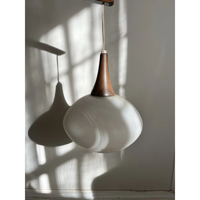 Midcentury modern MCM swivel pendant wall lamp. In excellent vintage condition. Walnut frame with a frosted glass globe....
