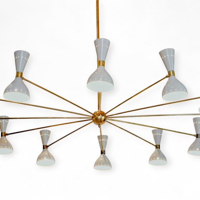 A fantastic Italian Mid-Century ceiling lamp by Stilnovo. The lamp features a central, gilded brass sphere from which...