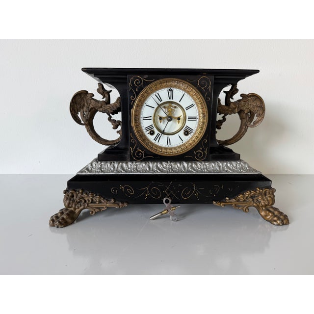 Impressive antique Ansonia “Belgium” mantel clock featuring an ornate architectural design with a black finish, gilt...