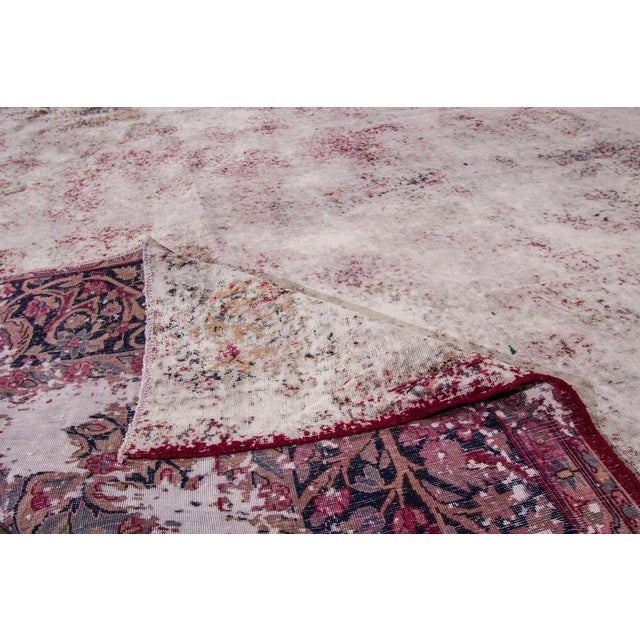A hand-knotted Overdyed rug with an allover design. This rug measures 9'3" x 12'3".