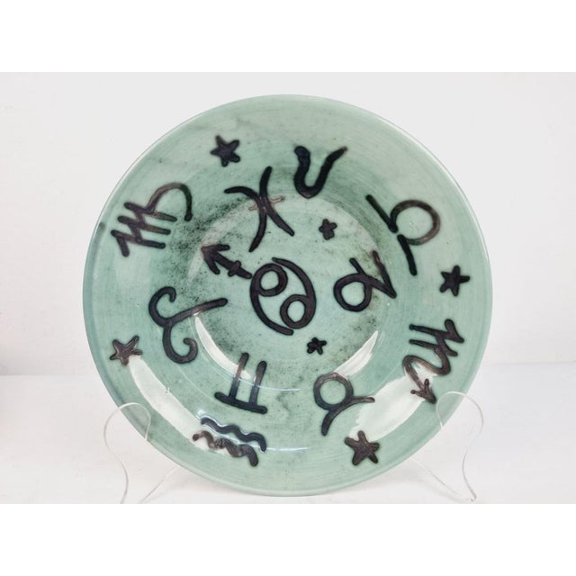 Mid century decorative plate with a horoscope design made by the hungarian ceramist Géza Gorka in the 1960s. Dimensions:...