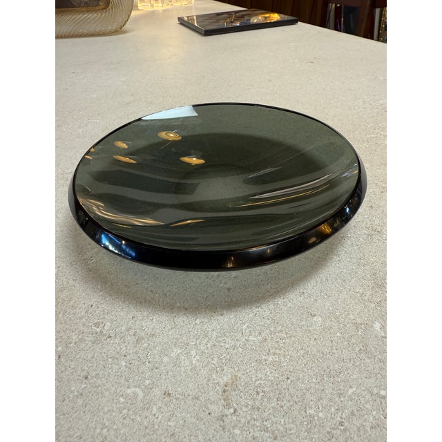 Refined smoked glass centerpiece by Fontana Arte, Italy, 1970s. This low, concave form is crafted in thick, polished...