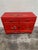 This is a great pop of red! Hand painted floral design. Top two drawers are lined in felt. There is one removable shelf...