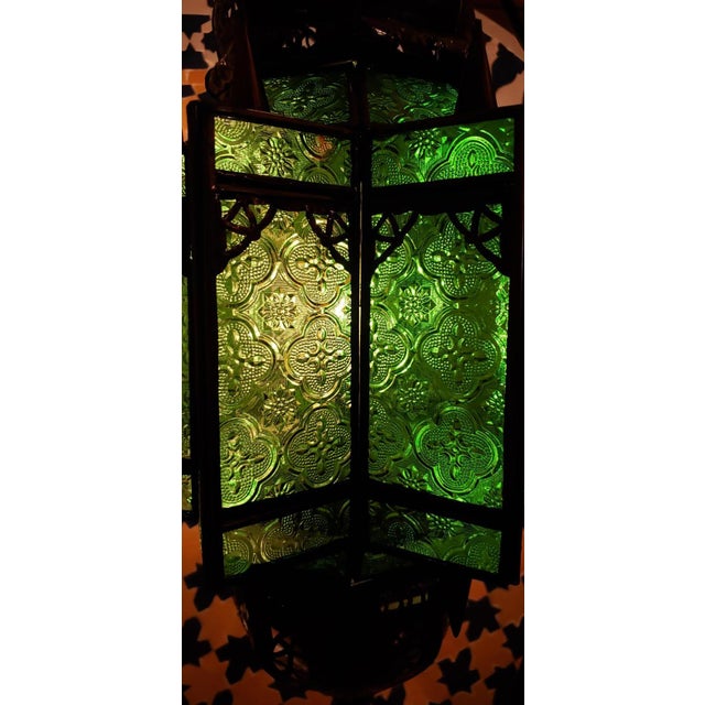 Handmade Moroccan glass lantern with frosty green stain glass and metal rustic frame, measuring around 23" in height and...