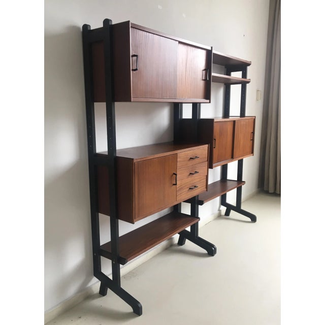 This wall unit was designed in the Netherlands in the 1960s and manufactured by SimplaLux. It consists of two separate...