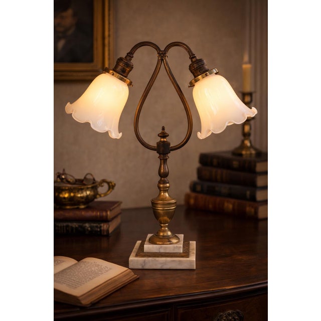 Refined antique table lamp featuring a graceful double-arm neoclassical design, crafted in brass with a warm original...