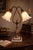 Refined antique table lamp featuring a graceful double-arm neoclassical design, crafted in brass with a warm original...