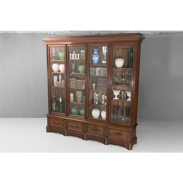 Four door mahogany library bookcase on four drawer base. Circa 1870.