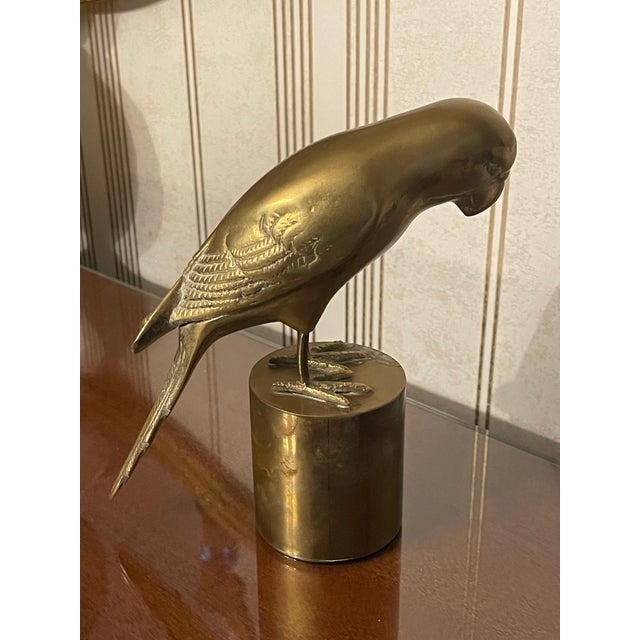 Mid century modern solid brass bird on pedestal. Solid and stately piece. Perfect for your bookshelf or table.